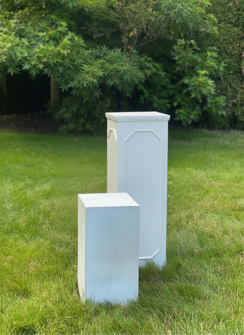 White concrete fibre pillars to display flower arrangements and candles on for wedding and events. Two sizes small and large.