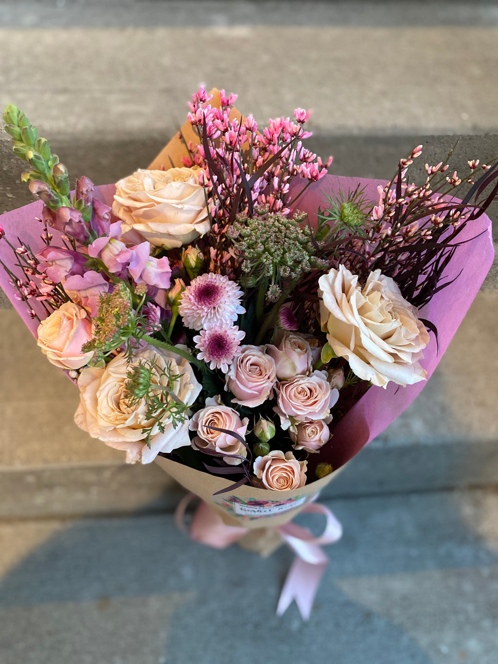 Lush hand-tied bouquet for Valentine's Day, featuring a selection of gorgeous, seasonally grown flowers and foliage, accentuated with ribbon.