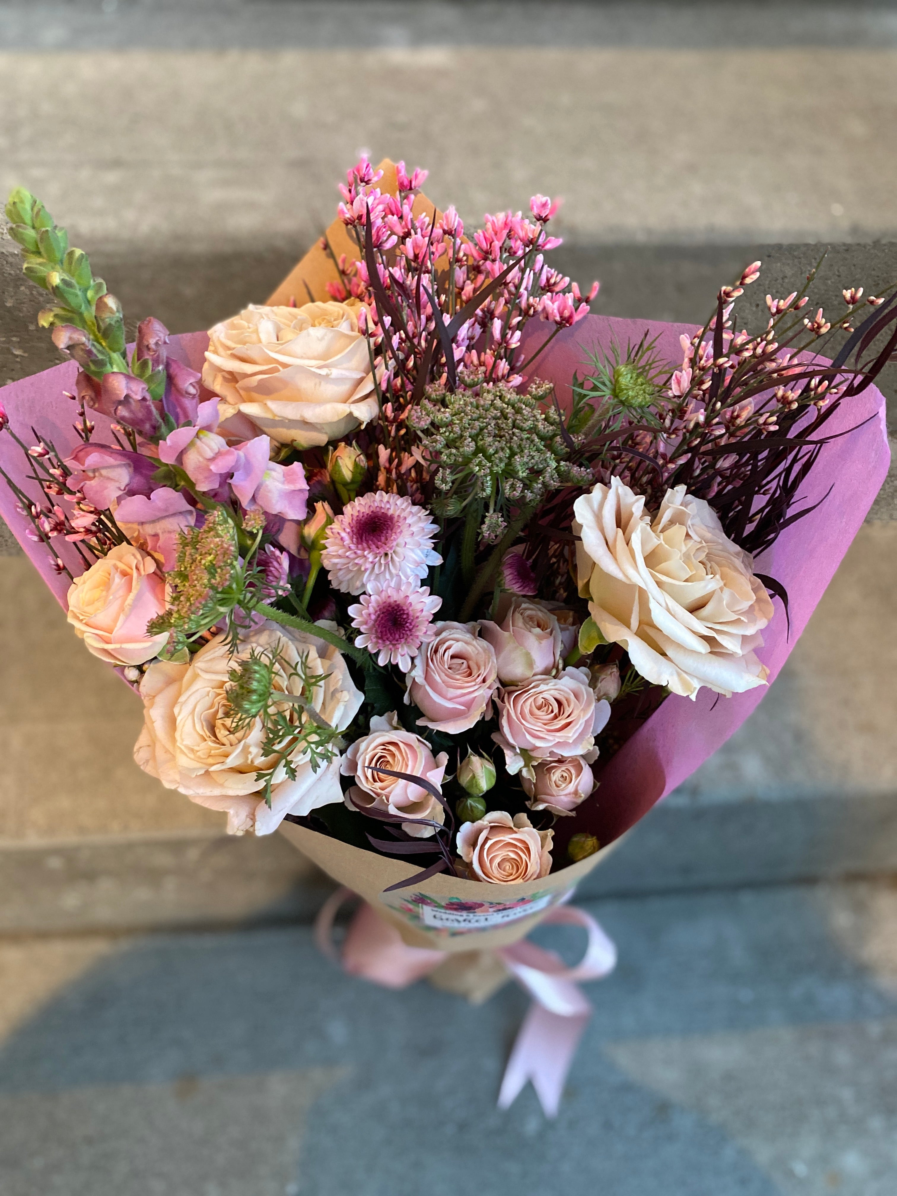 Lush hand-tied bouquet for Valentine's Day, featuring a selection of gorgeous, seasonally grown flowers and foliage, accentuated with ribbon.