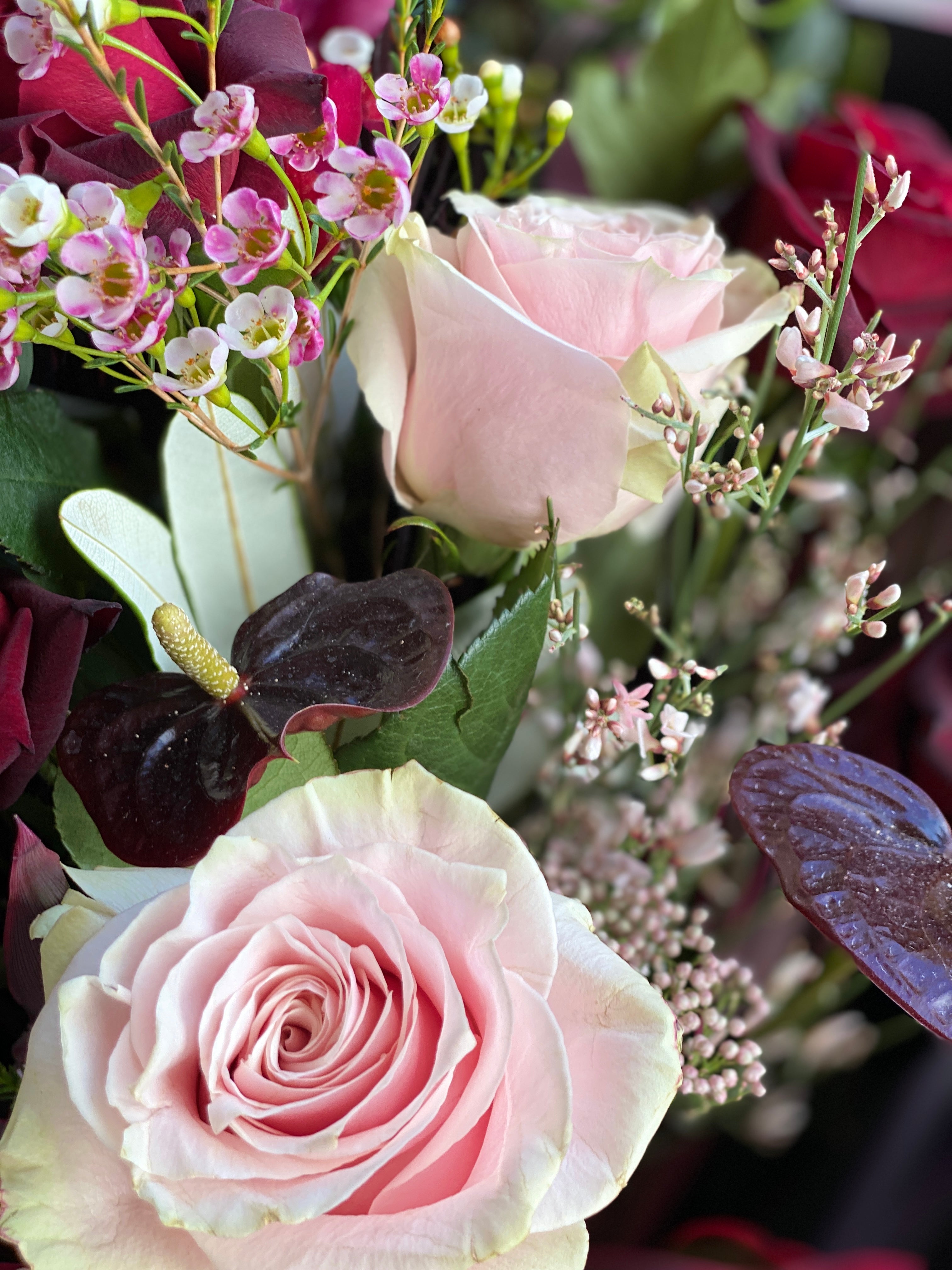 Lush hand-tied bouquet for Valentine's Day, featuring a selection of gorgeous, seasonally grown flowers and foliage, accentuated with ribbon.