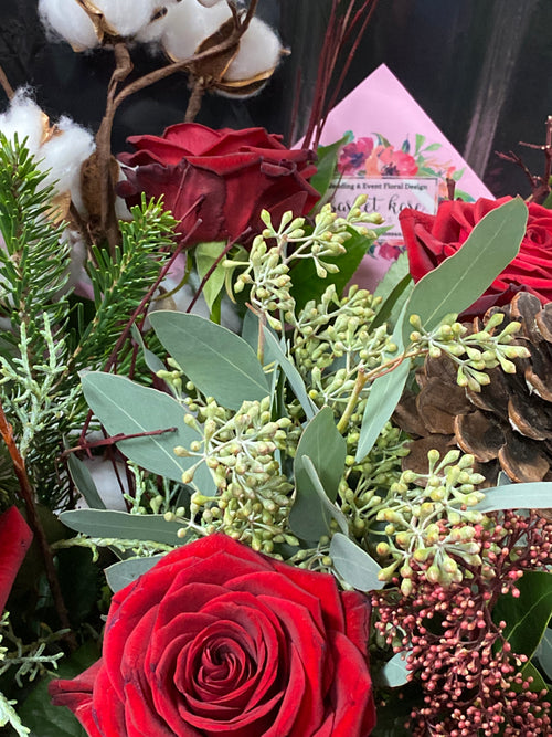 BKC4U Bespoke Holiday bouquet featuring roses, cotton stem, cones, and evergreens.