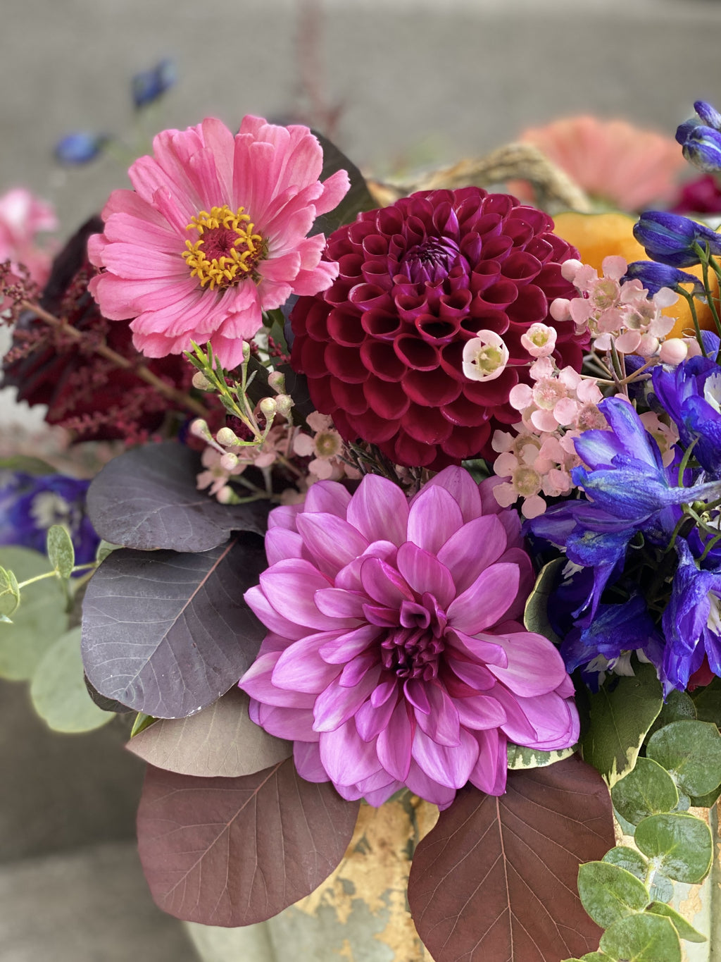 Colorful flower arrangement with pink, purple, and blue flowers.